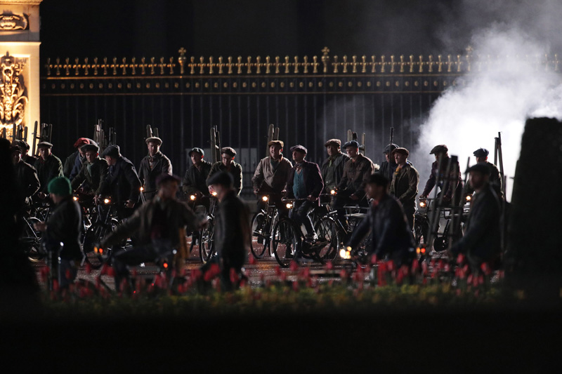 Extras riding bicycles prepare to take part in filming of a scene from the movie sequel Mary Poppins Returns in front of Buckingham Palace, central London. (Photo by Yui Mok/PA Images via Getty Images)